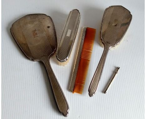 An Art Deco silver brush set with engine turned design, vacant cartouche by W J Myatt & Co., Birmingham, 1934 and a silver sw