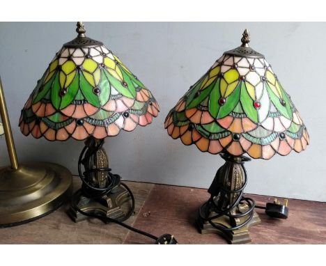 A brass-framed floor lamp with Tiffany-style shade, a matching side lamp and a pair of Art Nouveau-style table lamps with Tif