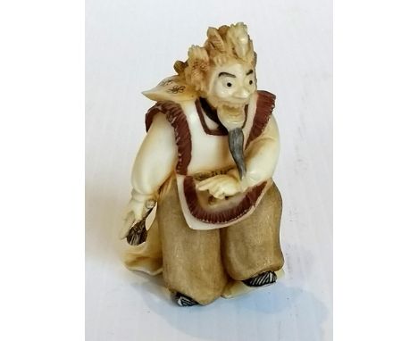 A late 19th /early 20th century Japanese ivory-carved netsuke of a bearded man, signed to base, without damage or repair 