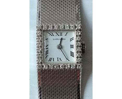 A ladies vintage Longines 18k white gold diamond bezel cocktail watch with Roman numerals, manual wind, surrounded by 28 roun