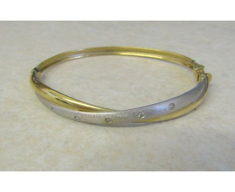 9ct gold bangle, two tone effect with cubic zirconia accents total weight 6.4 g