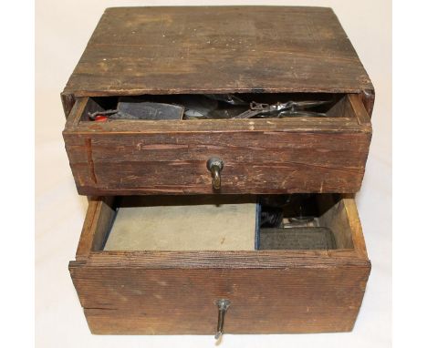 2 drawer cabinet containing watchmakers tools, keys and parts