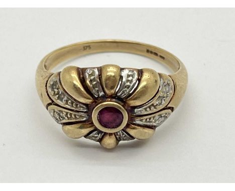 A 9ct Gold Stone Set Dress Ring, of two-tone abstract scroll design, the rubover set centre stone to diamond shoulders (finge