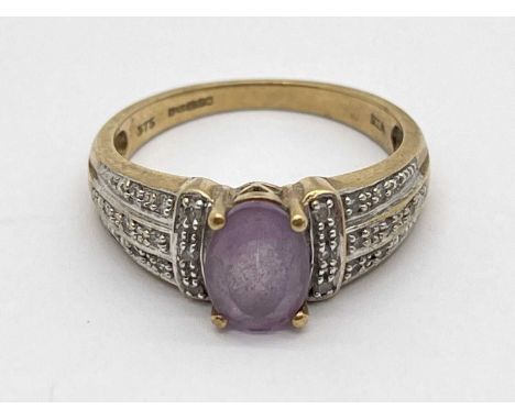 A 9ct Gold Stone Set Ring, oval claw set to centre, between diamond set tapered shoulders (finger size P) (3.5grams).
