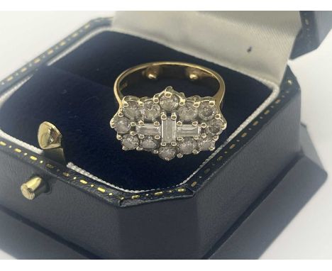 An 18ct Gold Diamond Cluster Ring, of shaped design, claw set with brilliant cut and baguette cut stones (approximate finger 