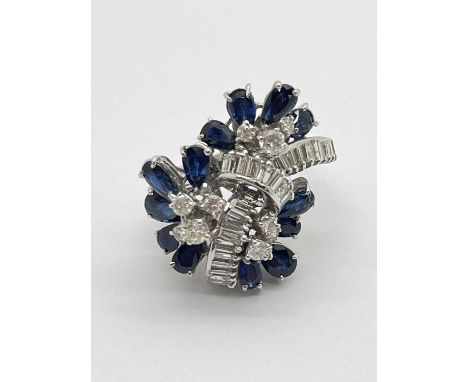A Large Sapphire and Diamond Cocktail Dress Ring, of abstract design, claw set throughout with graduated brilliant and baguet