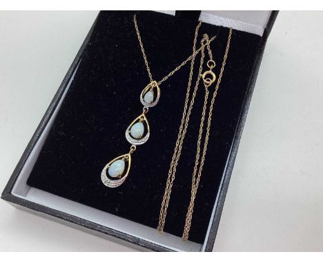 A 9ct Gold Opal Set Pendant, of graduated drop design, suspended on a dainty fine link chain stamped "375" (1.9grams).