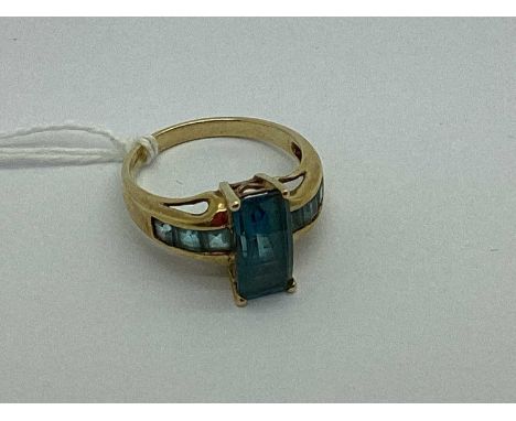 A 9ct Gold Stone Set Dress Ring, the elongated centre stone to four claw setting, stone set shoulders of tapered design (fing