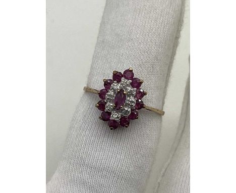 A 9ct Gold Stone Set Cluster Ring, the marquise shape centre stone within diamond set border (finger size S1/2).