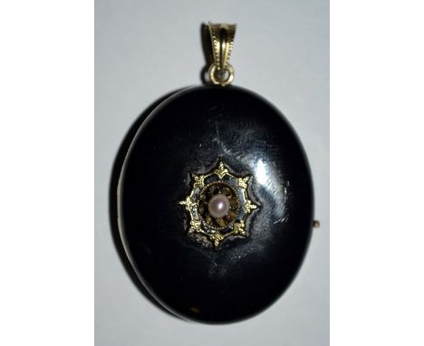 A Victorian jet and seed pearl mourning locket, oval jet body central set with a single claw set pearl within a floral frame,
