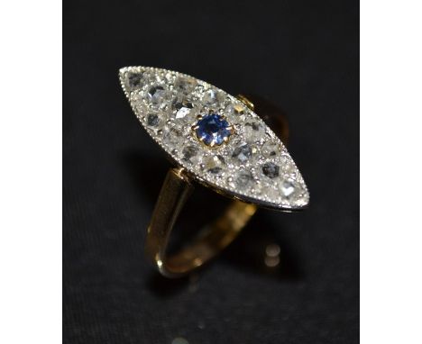 A diamond and sapphire marquise cluster ring, central round cur pale blue sapphire surround by a marquise crown inset with tw