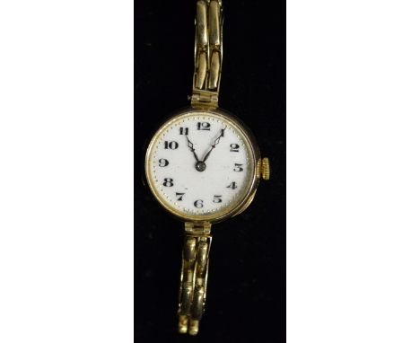 Rolex - a vintage lady's 9ct gold 15 jewel wrist watch, white enamel dial, bold Roman numerals, minute track, manual movement