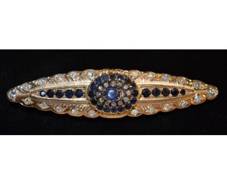 A diamond & sapphire brooch, central oval blue cabochon sapphire, surround by two stepped bands of twelve round old cut diamo
