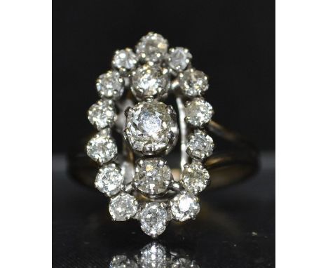 A French Art Deco seventeen stone diamond cluster ring, open oval crest with a central round brilliant cut diamond, raised ab