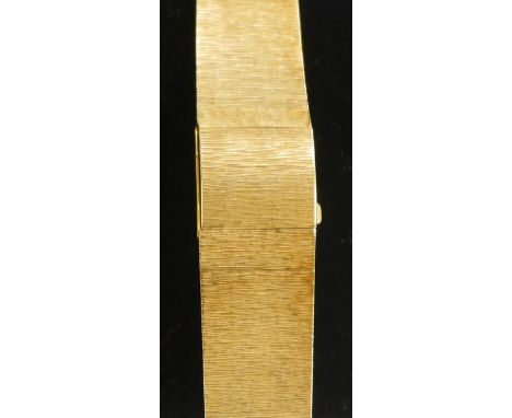 A lady's 18ct gold bracelet watch, invisible hidden dial, hinged cover revealing a silvered square dial, baton markers, seven