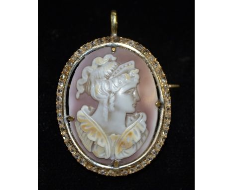 A neoclassical diamond and cameo pendant brooch,central oval shell carved portrait of a Maiden with tiara and flowing hair, s