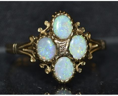 An opal four stone cluster ring, four oval opals each flashing green, blue, orange colour play, 9ct gols shank, size U, 3.2g 