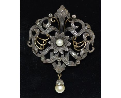 An Art Nouveau rose cut diamond and pearl floral pendant brooch, central pearl mounted flower head wrapped within a scrolling