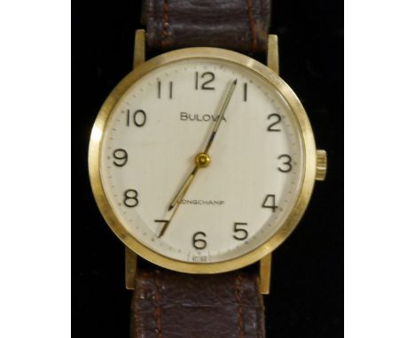 Bulova - a vintage 1970s Longchamp 9ct gold wrist watch, silvered dial, Arabic numerals, manual movement, brown leather strap