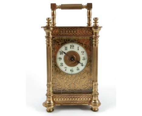 A brass cased carriage clock, the decorated case with fluted columns and scrolls, having an enamel chapter ring and gilt plat