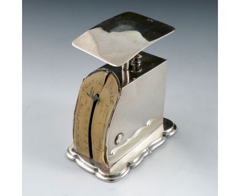 A set of silver postal scales, with pan to the top, the curved front with ivorine engraved scale, on a shaped base, Birmingha