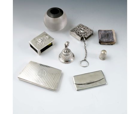 A collection of hallmarked silver, to include a purse with engine turning and initials, a pierced miniature book holder conta