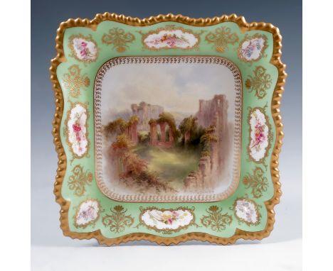 A square shaped Royal Worcester plate, decorated with a view of Kenilworth Castle to a green border with floral vignettes, by