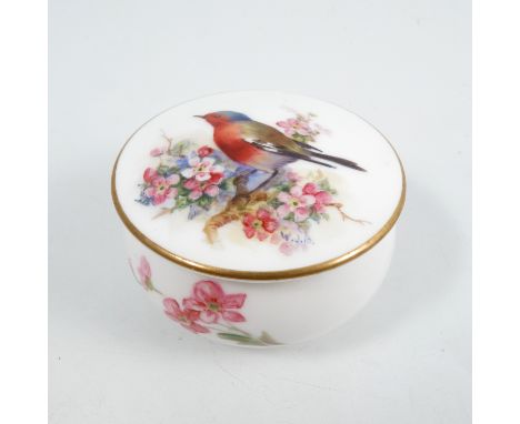 A small Royal Worcester covered patchbox, decorated with a bullfinch and apple blossom, monogrammed WJP 1924, diameter 2.5ins