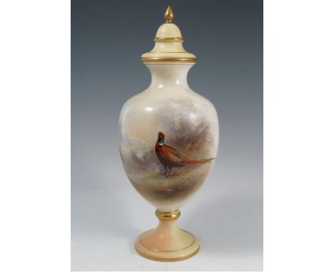 A Royal Worcester covered vase, decorated with a cock pheasant, with small vignette to the reverse by James Stinton, to a blu