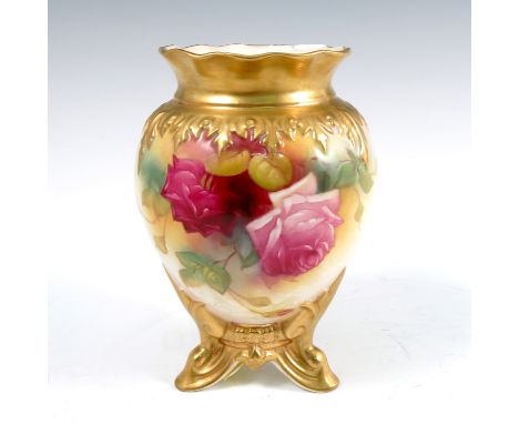 A Royal Worcester vase, decorated with roses by M Hunt, gilt edge and raised on three gilt feet, shape number H245, dated 193
