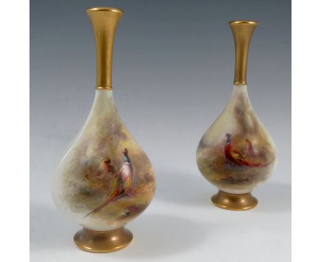 A pair of Royal Worcester vases, decorated with a cock and hen pheasant in a landscape, with small vignettes to the reverse, 