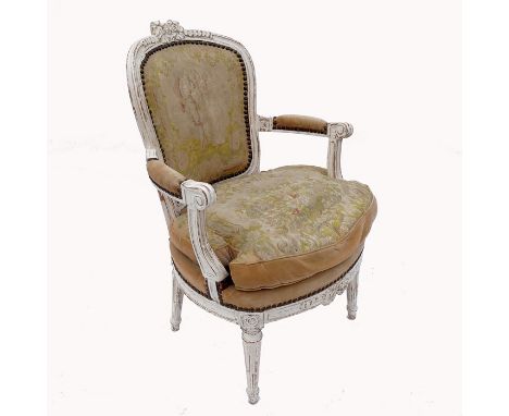 An 18th century Louis XVI painted walnut fauteuil, with carved bows to front and crest rail and having Aubusson style tapestr