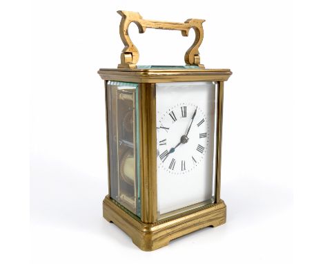 A brass cased carriage clock, with striking movement, the white enamel dial having Roman numerals, movement stamped R &amp; C