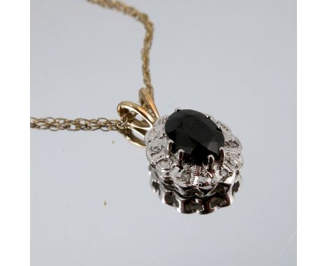 A sapphire and diamond oval cluster pendant, the central sapphire enclosed by single cuts, on a chain, 2.5g gross
