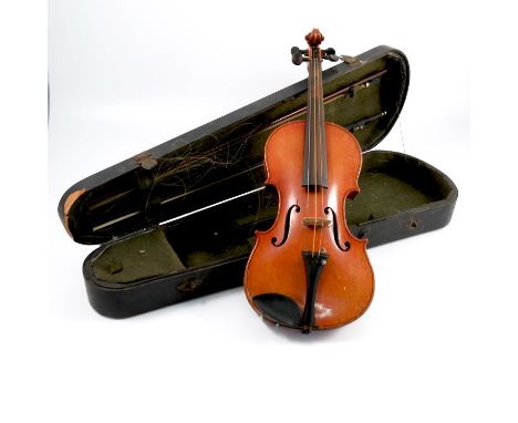 A cased Violin, bearing label Josef Guarnerius fecit Cremona anno 1743 IHS, two piece back, length 14.25ins excluding button,