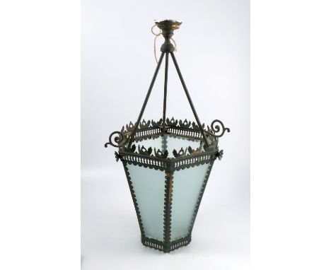 A metal hanging lamp shade, of hexagonal form, with leaf border over a pierced band, with frosted glass panels, overall heigh