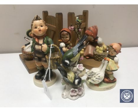 A pair of Hummel bookends, three further Hummel figures - village boy, apple tree girl, goose girl and a Goebel bird figure 