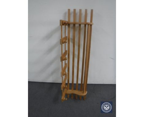 A pine hat and coat rack with shelf 