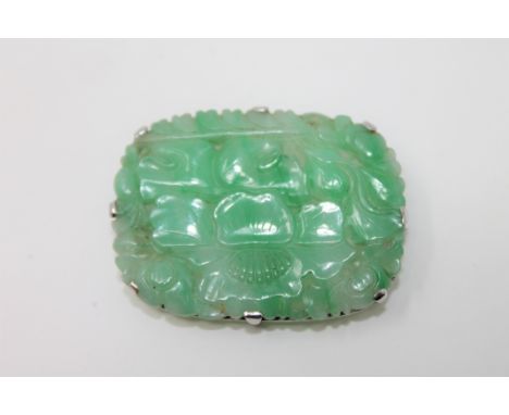 A carved jade plaque set in white metal CONDITION REPORT: 2.8cm by 3.9cm. In good condition. 10.6g. 