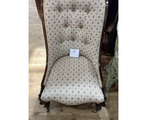 Victorian rosewood nursing chair with button back floral upholstery.
