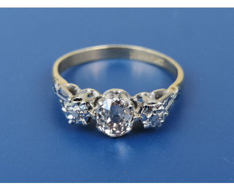 A 'three stone' illusion diamond ring, claw set with a single cushion cut diamond weighing approximately 0.60 carat in 18ct &
