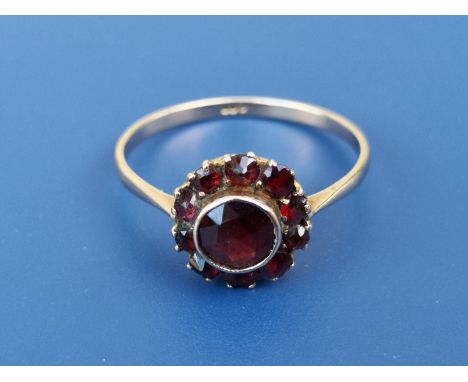 An Edwardian 9ct gold Bohemian garnet cluster ring.  Finger size P.