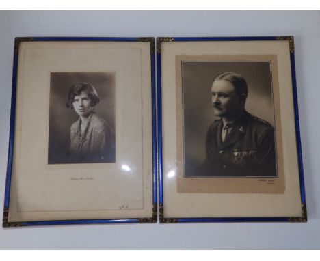 A pair of early 20thC gilt metal photo frames with blue guilloche enamel decoration,  12" x 9" overall. (2)