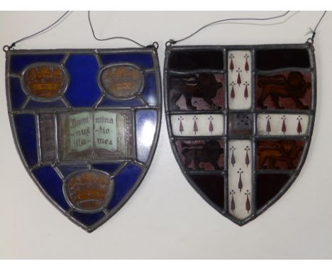 Two  stained glass leaded light heralic shield panels - one inscribed 'Dominus illuminatio mea',  9" high.