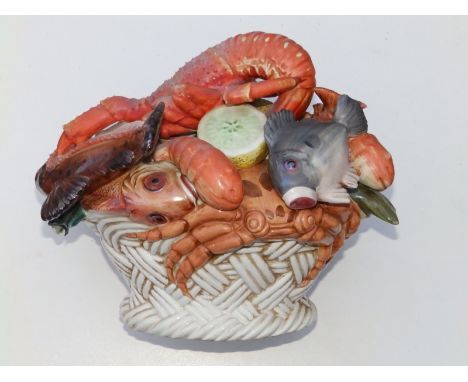 A 20thC continental ceramic study of a basket of seafood, 12" across.