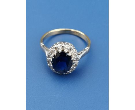 An oval sapphire &amp; diamond cluster ring on yellow 18ct shank.  Finger size L.