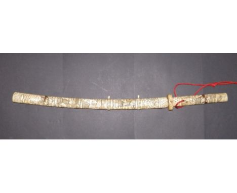 A Japanese sword, the scabbard and hilt veneered in bone and carved in shallow relief to depict numerous figures, 33" overall