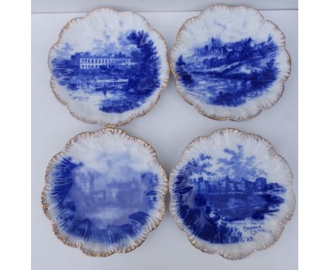 A set of four flow blue pottery plates with gilt scalloped borders, decorated with 'castle' scenes including Buckingham Palac