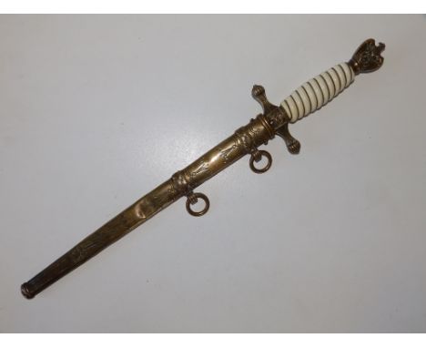 A German Kriesmarine dagger with ivorine hilt, Solingen blade, in brass scabbard, 16.5" overall.