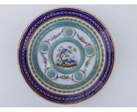 A 19thC Sevres porcelain cabinet plate in the neoclassical style, painted in polychrome with a central roundel depicting two 